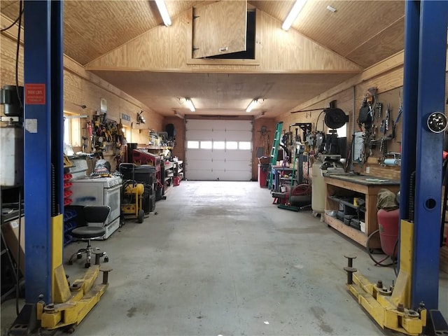 garage featuring wooden ceiling and a workshop area