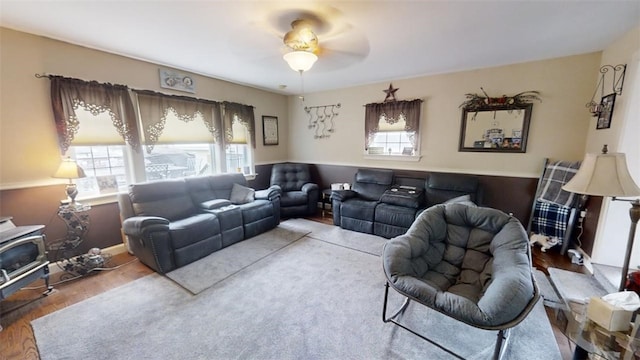 living room featuring ceiling fan and wood-type flooring