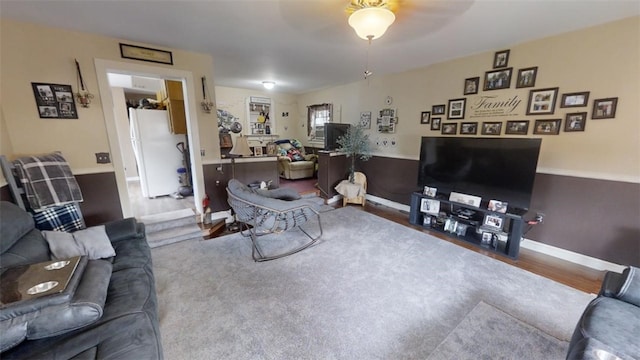 living room with ceiling fan and wood-type flooring