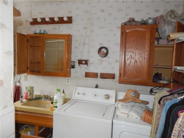 clothes washing area with independent washer and dryer