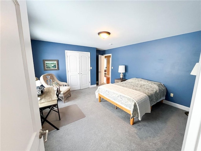 bedroom with a closet and carpet flooring