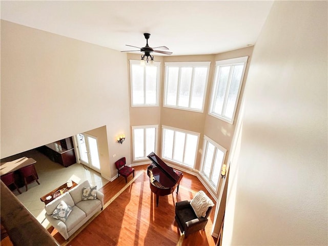 living room with ceiling fan and wood-type flooring