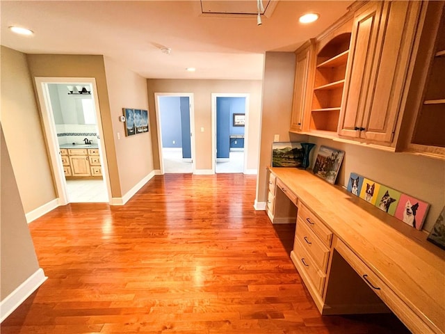 hallway with light hardwood / wood-style floors