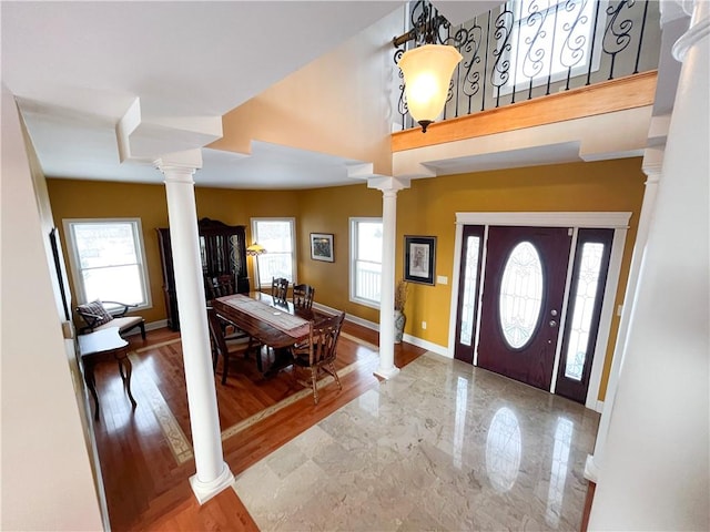 entryway featuring a healthy amount of sunlight and decorative columns