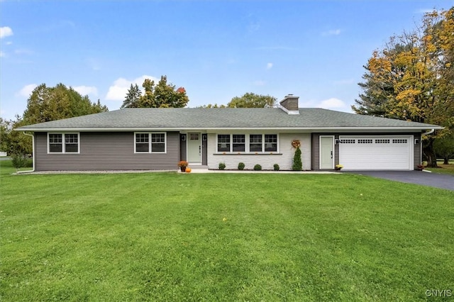 ranch-style house with a garage and a front lawn