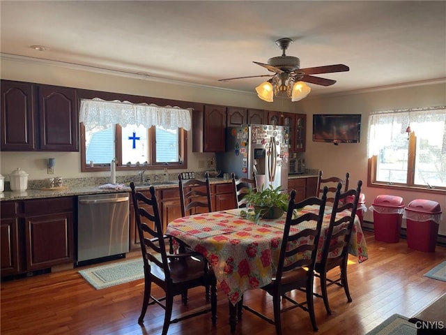 dining space featuring a wealth of natural light, dark hardwood / wood-style flooring, and ornamental molding