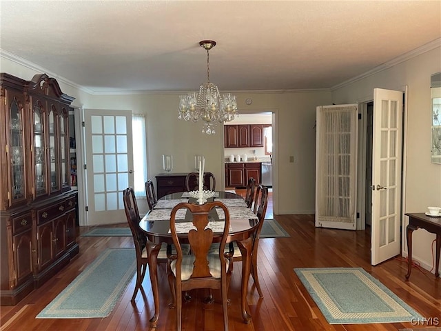 dining area featuring french doors, ornamental molding, a chandelier, and dark hardwood / wood-style flooring