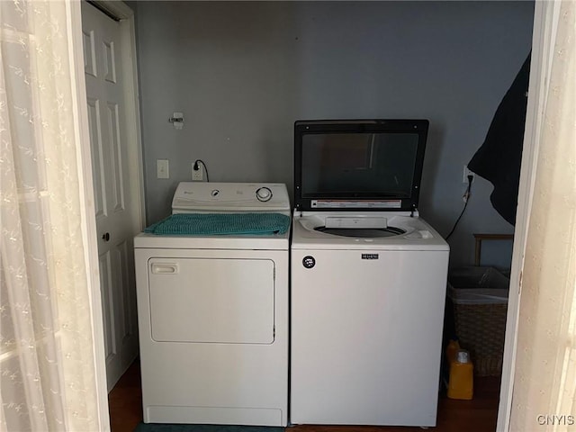 clothes washing area with separate washer and dryer