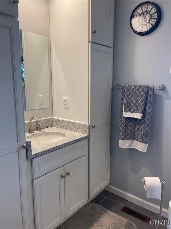 bathroom featuring tile patterned flooring and vanity