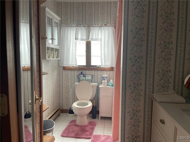 bathroom with toilet, a healthy amount of sunlight, a baseboard heating unit, and tile patterned floors