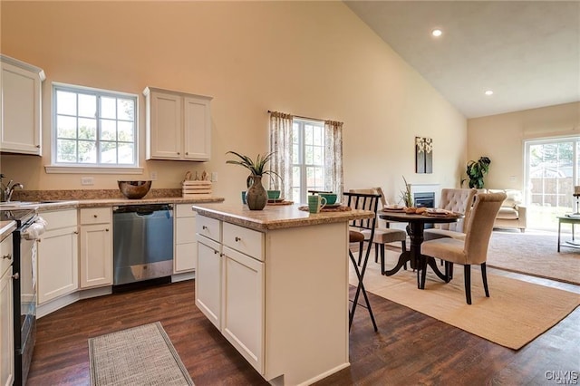 kitchen with dishwasher, a center island, black range with electric stovetop, dark hardwood / wood-style floors, and high vaulted ceiling