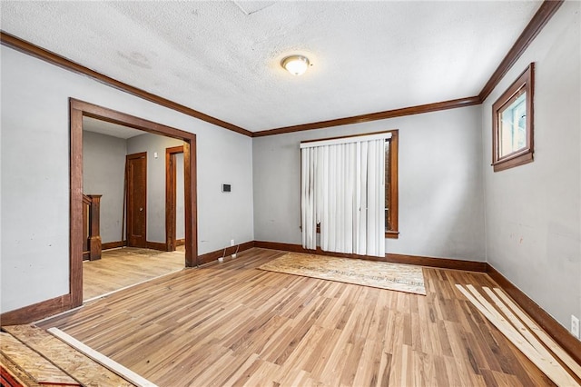 unfurnished bedroom with a textured ceiling, ornamental molding, and light hardwood / wood-style floors