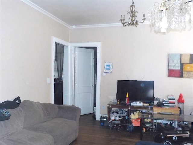 living room with dark hardwood / wood-style flooring, crown molding, and an inviting chandelier