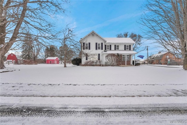 view of front of property with a storage shed