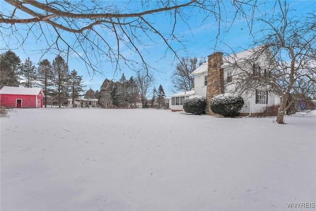 snowy yard with a sunroom