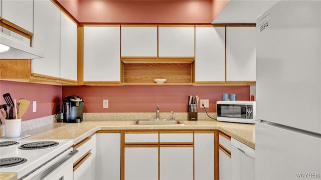 kitchen with white cabinets and white appliances