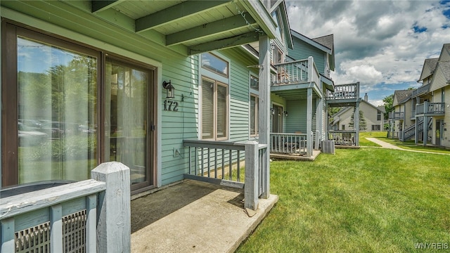 property entrance featuring a lawn and central AC