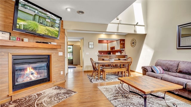 living room with a fireplace and light hardwood / wood-style floors