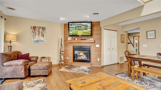 living room with a fireplace and hardwood / wood-style floors