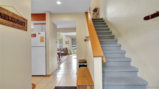 stairway with tile patterned flooring