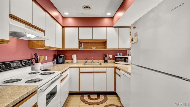 kitchen featuring white cabinets and white appliances