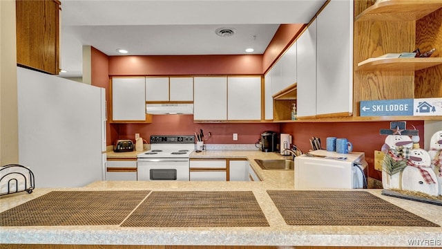 kitchen with white cabinetry, sink, and white appliances