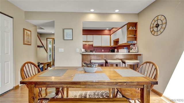 dining space with light hardwood / wood-style floors