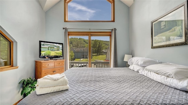 bedroom with access to outside and high vaulted ceiling