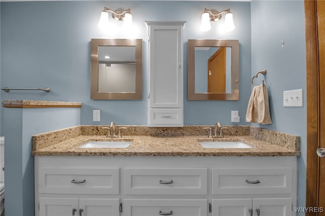 bathroom with toilet and vanity