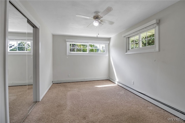 empty room with ceiling fan and baseboard heating