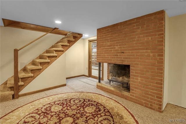 living room featuring carpet floors and a brick fireplace