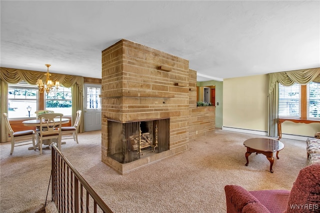 carpeted living room featuring baseboard heating, a fireplace, and a notable chandelier