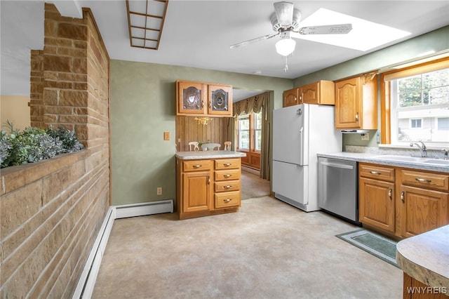 kitchen featuring white fridge, a healthy amount of sunlight, stainless steel dishwasher, and sink