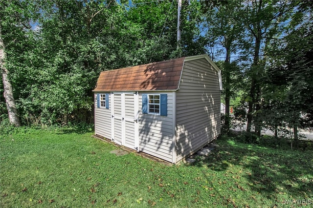 view of outbuilding with a lawn