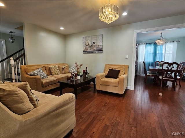 living room with dark wood-type flooring and a notable chandelier