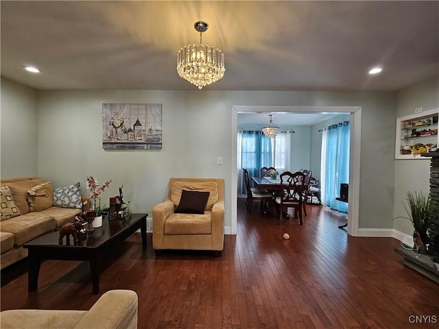 living room featuring dark hardwood / wood-style floors and a notable chandelier