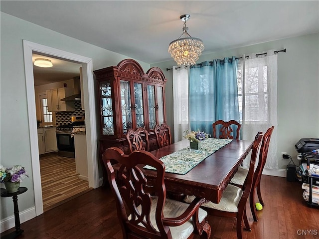 dining area featuring a chandelier and dark hardwood / wood-style floors