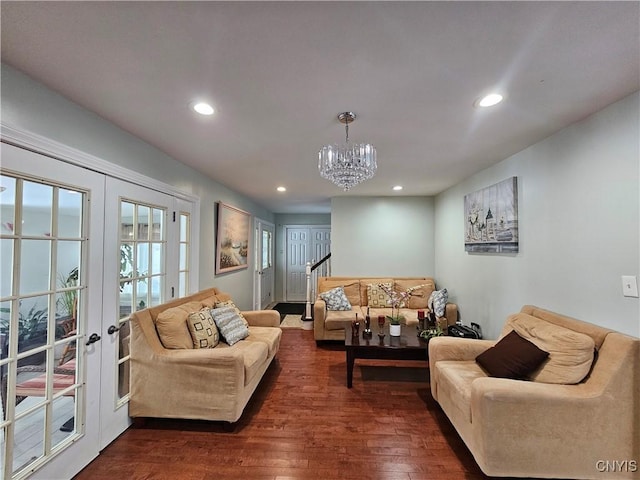 living room with french doors, dark hardwood / wood-style floors, and a notable chandelier