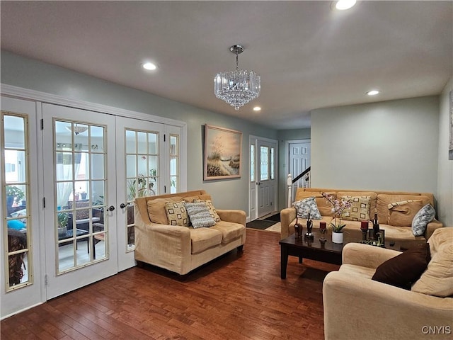 living room with french doors, dark hardwood / wood-style flooring, a wealth of natural light, and a notable chandelier