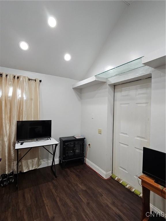 interior space with dark hardwood / wood-style floors and vaulted ceiling