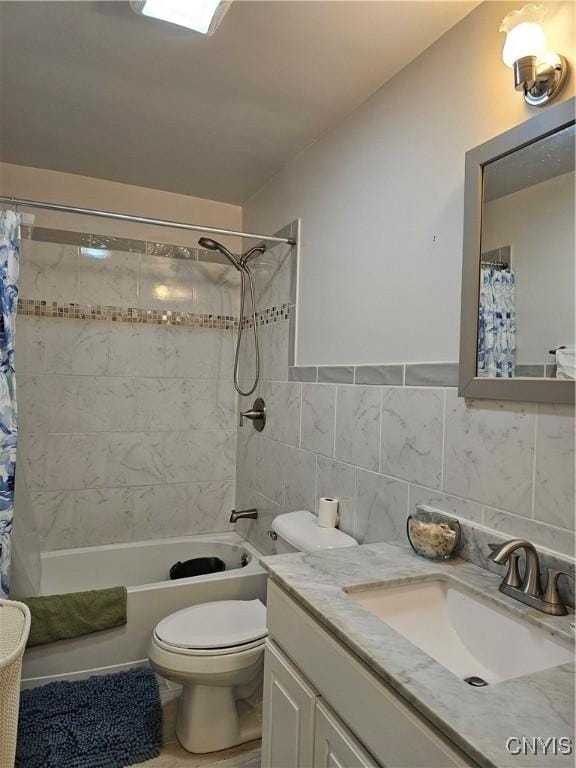 full bathroom featuring toilet, tile walls, shower / tub combo, and vanity