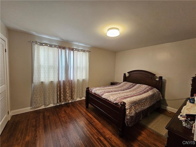 bedroom with dark hardwood / wood-style floors