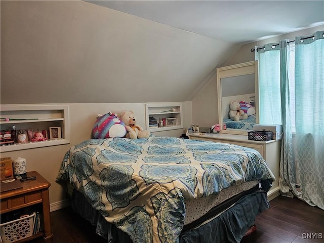 bedroom with dark hardwood / wood-style floors and lofted ceiling