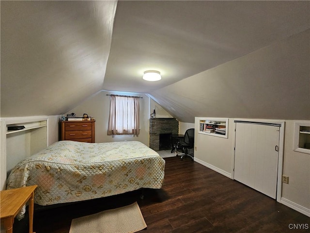 bedroom featuring vaulted ceiling and dark hardwood / wood-style flooring