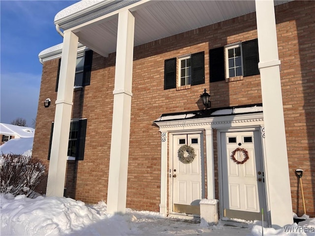 view of snow covered property entrance