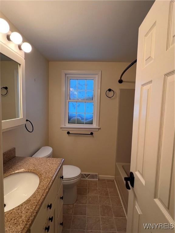 full bathroom featuring toilet, vanity, and shower / washtub combination