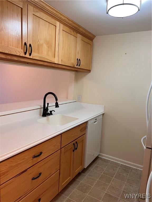 kitchen with white dishwasher and sink