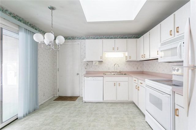 kitchen with pendant lighting, white appliances, white cabinets, an inviting chandelier, and sink