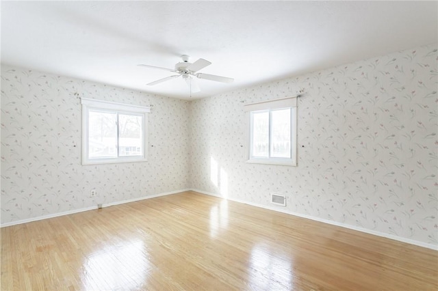 unfurnished room with ceiling fan and light hardwood / wood-style flooring