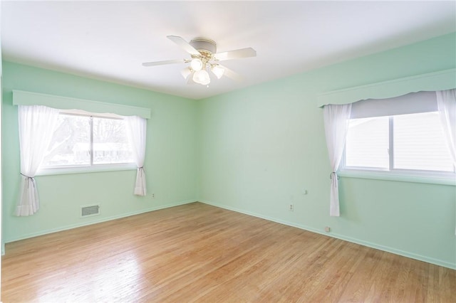 unfurnished room with ceiling fan, a healthy amount of sunlight, and light hardwood / wood-style flooring